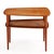 A finely crafted midcentury coffee/end table designed by Peter Hvidt, executed in solid teak with a woven cane lower tier....