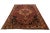This beautifully hand-knotted woolen rug, with its vibrant multi-colored medallion pattern set against a warm red...