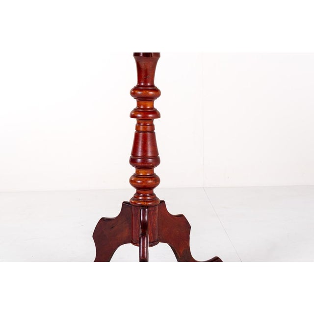 This lovely antique (19th century) mahogany tripod table is a charming piece that combines the timeless appeal of mahogany...