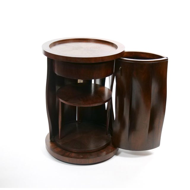 A refined Mid-Century Modern side table crafted from richly grained mahogany, featuring a distinctive cylindrical, drum-...