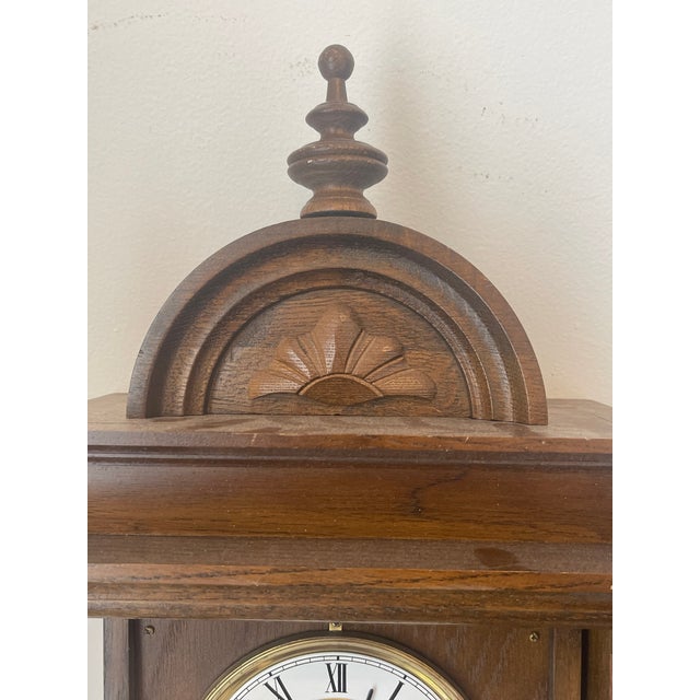 Antique windup mechanical clock 31 days wind up and chimes. Enamel face and pendulum. Working condition.