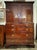 19th century mahogany cabinet with a dentil cornice and two paneled doors opening to an interior fitted with nine small...