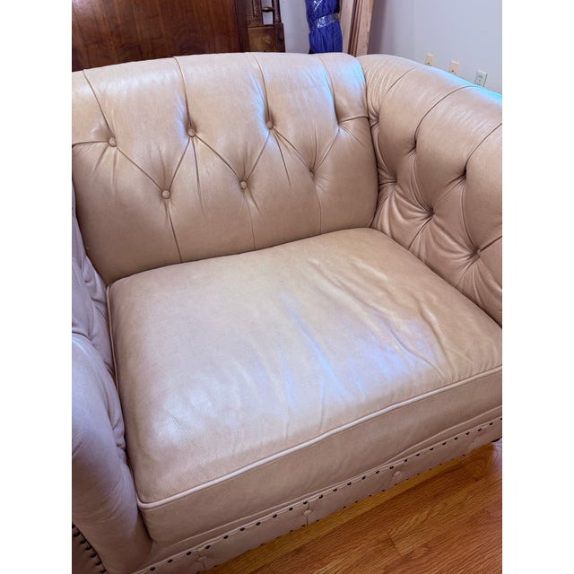 A handsome Bernhardt leather chair and ottoman set with classic Chesterfield-inspired styling and an inviting, lounge-...
