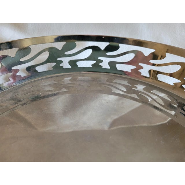 Super functional size with interesting details on this Italian made stainless steel serving tray - Looks to me like people...