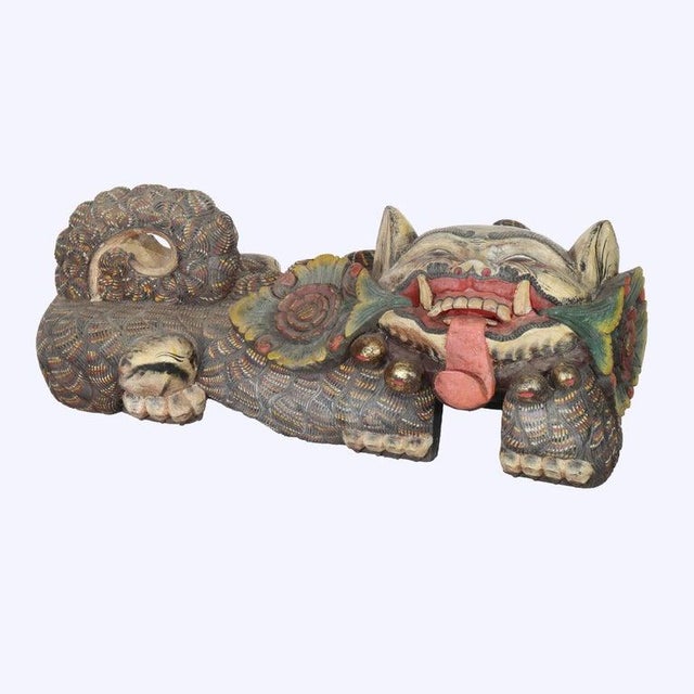 A distinguished pair of Chinese carved wood Foo Dogs, dating to the 20th Century, presents a captivating example of...