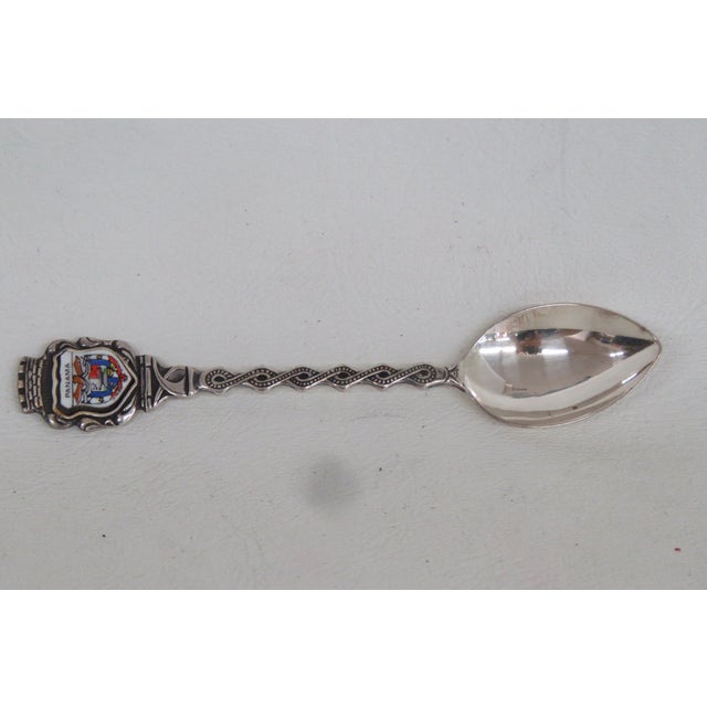 This lovely Souvenir Spoon is made out of metal. The back of the handle is stamped E.P.N.S for Electroplated Nickel...