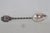 This lovely Souvenir Spoon is made out of metal. The back of the handle is stamped E.P.N.S for Electroplated Nickel...