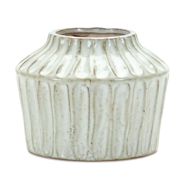 Add timeless charm to your home with the Rustic Carved Terracotta Vase. Its unique ribbed texture and warm beige and brown...