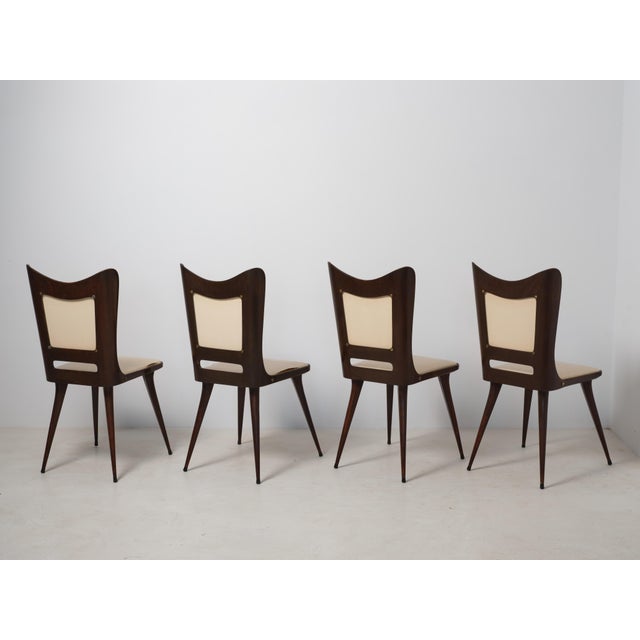 This set of four dining chairs was produced in Italy during the 1950s and reflects the clean, sculptural lines typical of...