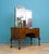 A striking tiger oak dressing table dating from the 1930s, featuring a shaped triple mirror, serpentine front and elegant...