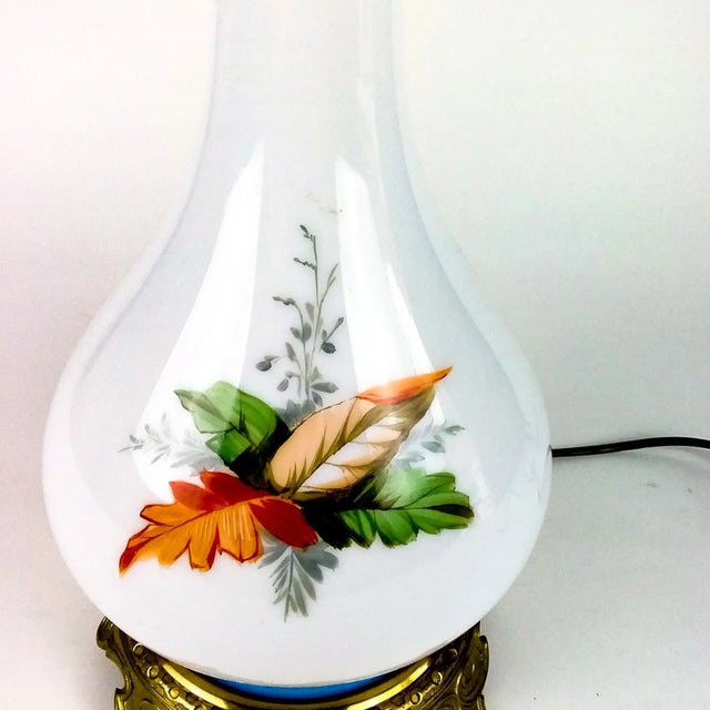 Very Rare hand blown glass lamp has been hand painted with a blonde cherub among palm leaves. This type of lamp with this...
