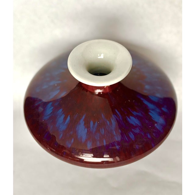 Striking vintage Chinese porcelain vase from Jingdezhen, finished in a dramatic flambé glaze with a deep oxblood-red...