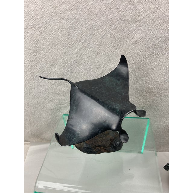 Heavy patinated bronze sculpture of Manta Ray swimming mounted on rocky base. Unsigned, possibly attributed to Robert...