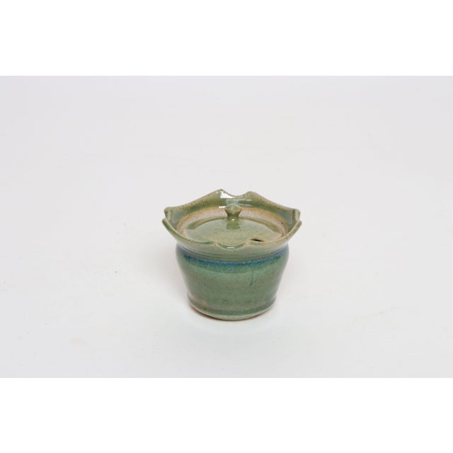 Variegated green studio ceramic lidded sugar bowl by ceramicist, Deanna Nichols (b. 1942-2017, Missouri). Holding a BFA...
