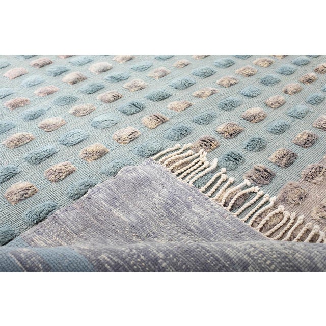 A field of pebbles, fading from stone to twilight. Rows of raised, dot-like tufts cover this piece in a rhythmic grid,...