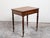 An English mahogany table from the 19th century, with single drawer, small compartment and reeded legs. Created in England...