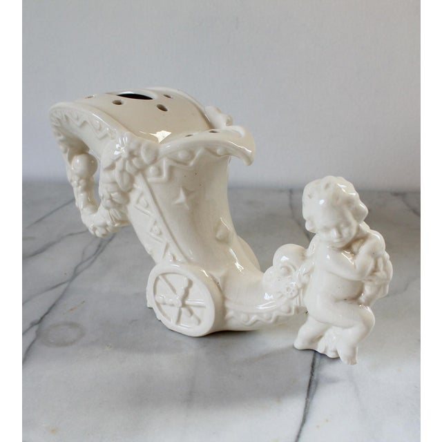 Vintage white flog frog vase of a cherub pulling a cornucopia carriage. Made in Germany. No chips or cracks. Minor...
