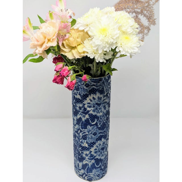 This blue and white vase with an intricate embossed lace pattern is feminine and modern, but a classic pairing of blue and...