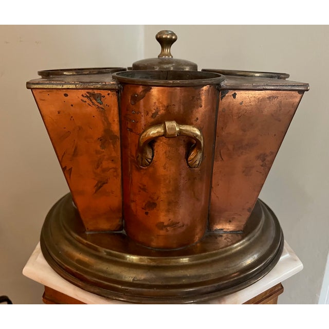 English Art Deco copper & brass wine cooler with 4 areas for individual bottles centering a covered opening to hold ice....