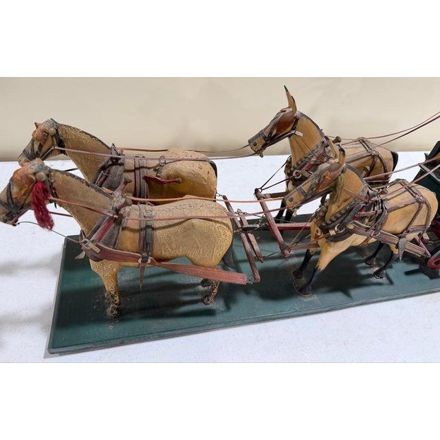 Wooden 19thc Folky Covered Wagon with four wooden horses all pulling a wagon and rider. The horse have cloth and leather...