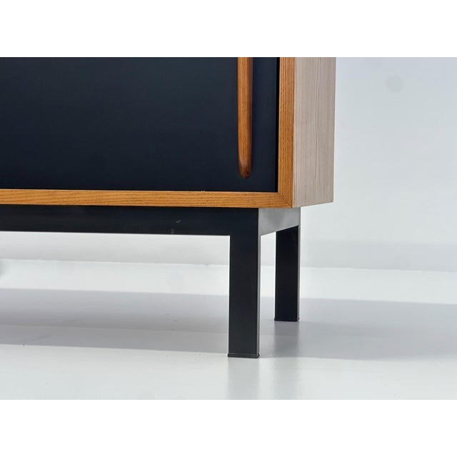 Sideboard designed by Charlotte Perriand, circa 1960. Produced by Steph Simon (France). Steel base, wooden frame and...