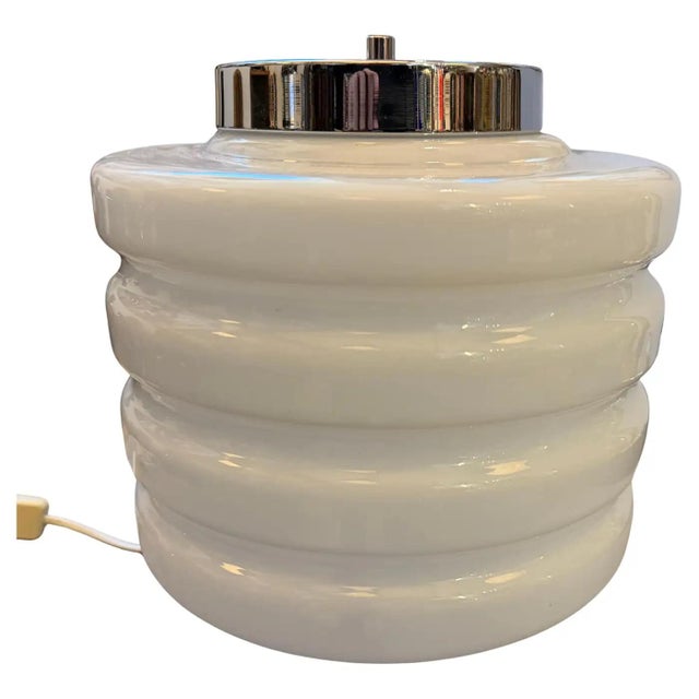 This striking Italian table lamp is a premier example of the 1990s revival of Space Age aesthetics, blending the...