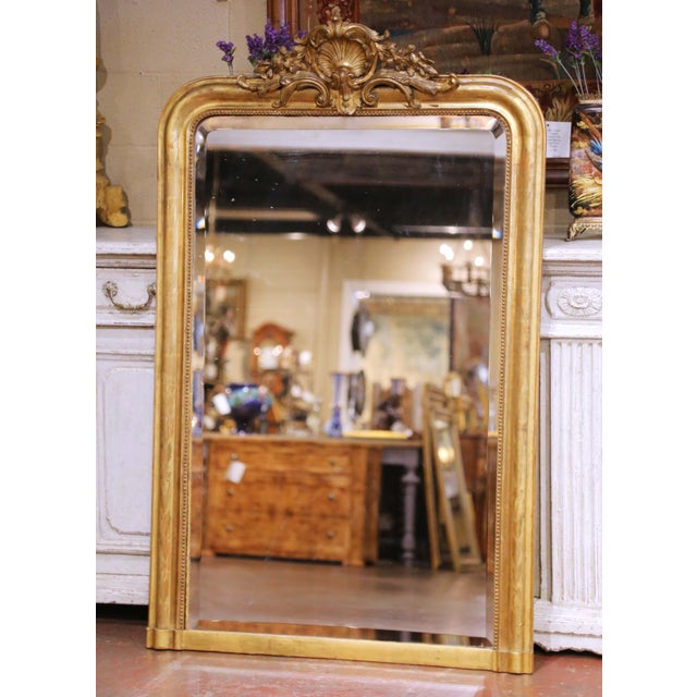 Circa 1870, this elegant antique French giltwood mantel mirror is designed in the Louis Philippe taste, featuring a...