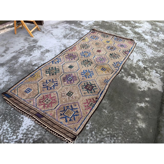 This is a vintage Turkish Anatolian kilim rug from the 1960s. The piece was hand-woven.