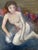 A small and expressive vintage figurative oil painting depicting a seated female nude. The figure is rendered with loose,...