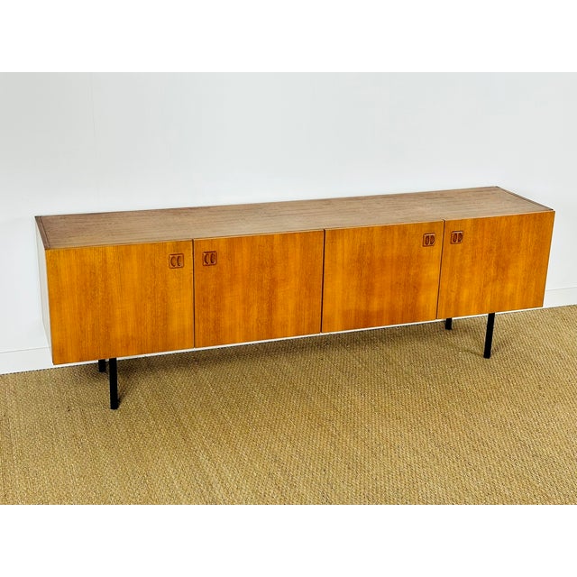 Magnificent vintage Scandinavian teak sideboard dating from the 1960s, featuring four storage doors with shelves. The...