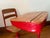 Midcentury children's school desk with a wooden writing top and a pencil groove. The frame is red painted metal and the...