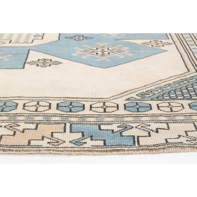 This is a vintage Turkish Oushak rug from the 1960s. The piece was hand-knotted.