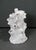 A sculptural white ceramic tree trunk vase featuring 18 openings for individual stems or floral arranging. The faux bois...