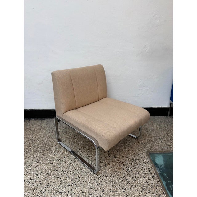 Elegant upholstered cantilever lounge chair dating from approximately the 1970s. The chair features a sculptural tubular...