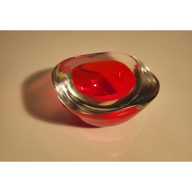 Red and yellow Murano glass emptier, crafted using the "sommerso" technique, which creates overlapping layers of colored...