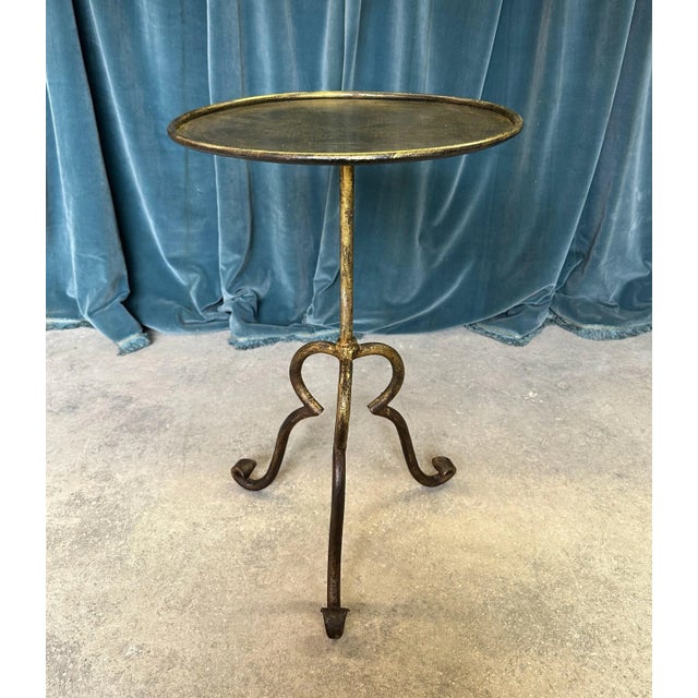 A unique small scaled side table, recently made by European artisans, has a hand applied gold finish and is mounted on a...