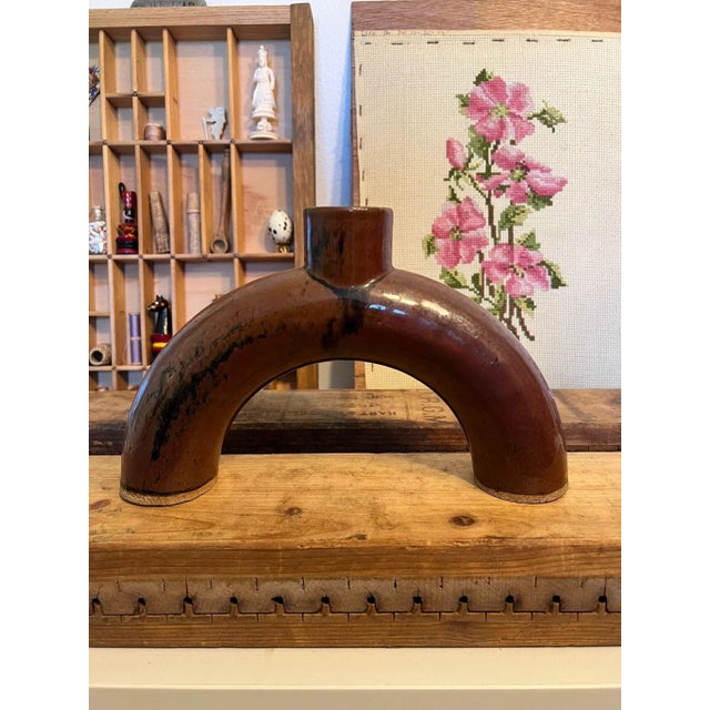 Semicircle shaped ceramic vase, bronze in color. Vintage Condition as pictured.Listing is only for described item....