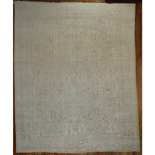 Description an early 20th-century Antique Persian Tabriz Rug in white and soft brown. The large-scale all-over design...