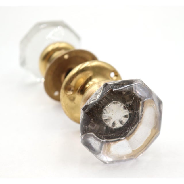 Vintage door knob set with octagon shaped clear glass door knobs paired with newly made brass rosettes. Priced as two door...
