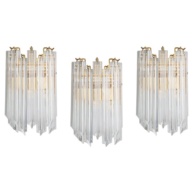 Each wall light is composed of 9 crystal glasses and a gilt brass frame design in venini style, italy. Manufactured circa...