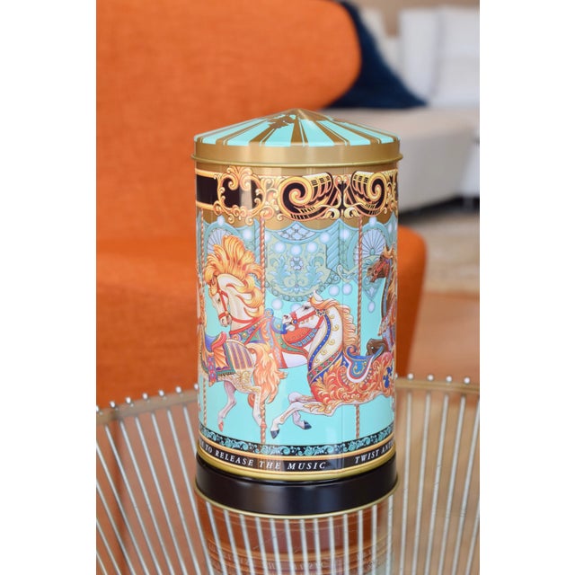 FORTNUM & MASON'S MERRY-GO-ROUND MUSICAL TIN Era: 2010s Size: 7" height x 3.5" diameter OVERVIEW: A charming musical...