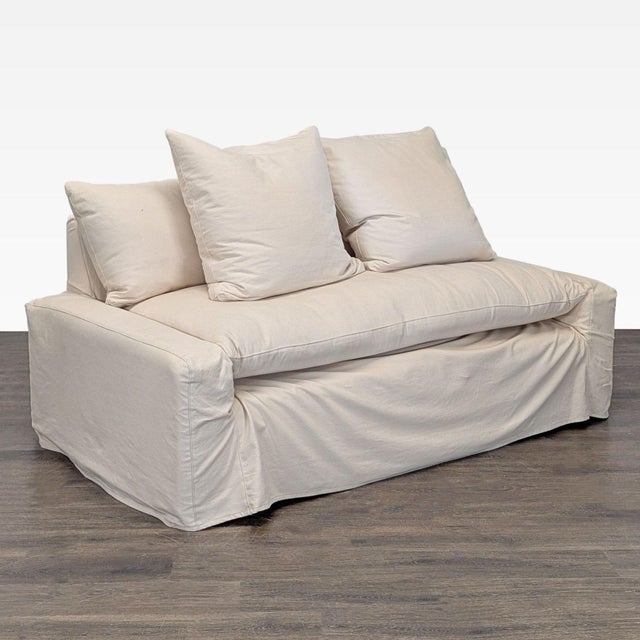 This Crate & Barrel loveseat offers a cozy and modern look with its clean cream slipcover and plush, removable cushions....