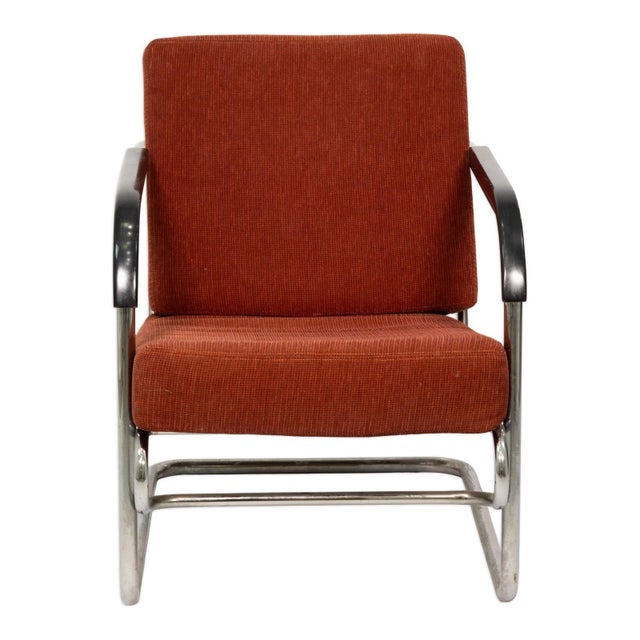 Pair of armchairs constructed with tubular steel frames in the Bauhaus manner. Each chair features a continuous bent steel...