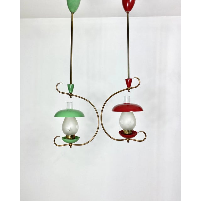 Pair of two chandelier pendant in metal and brass details, in the shape of two mushrooms, green and red. The lampshades...
