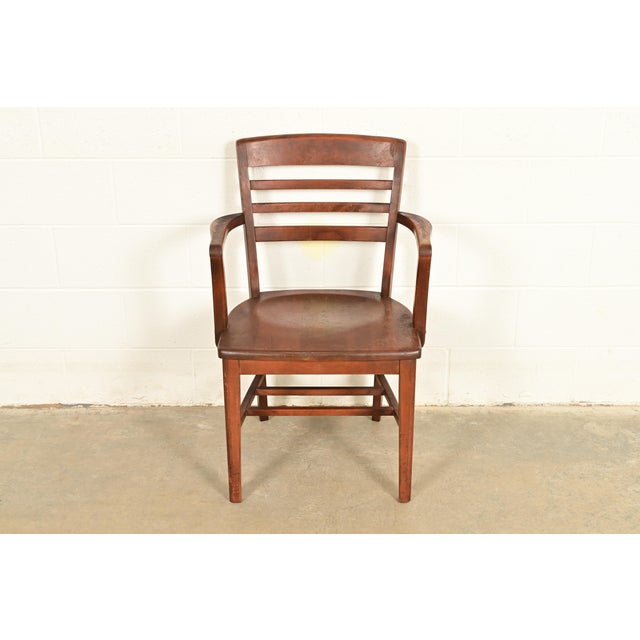 An exceptional antique Arts & Crafts or Art Deco period carved walnut banker, juror, or lawyer chair In the manner of...