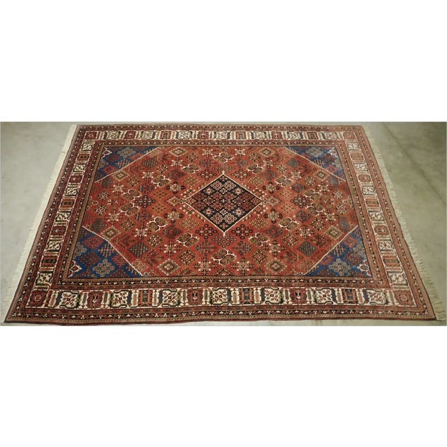 Central medallion with reciprocating corners. Rust field decorated with intricate motif. Rare ivory border. 11'x 7'6"