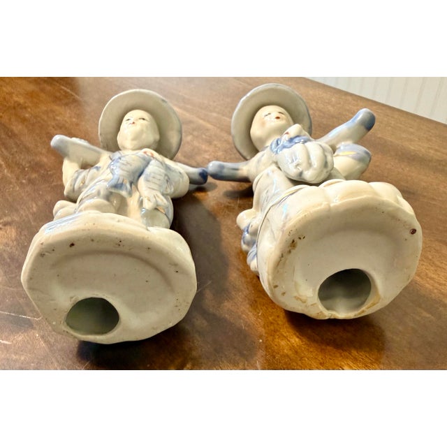 This is a pair of vintage Chinese figurines, distinguished by their classic blue and white underglaze decoration. Each...