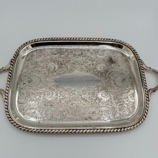 A richly detailed American silverplate serving tray by Sheffield Silver Company, its surface almost entirely given over to...