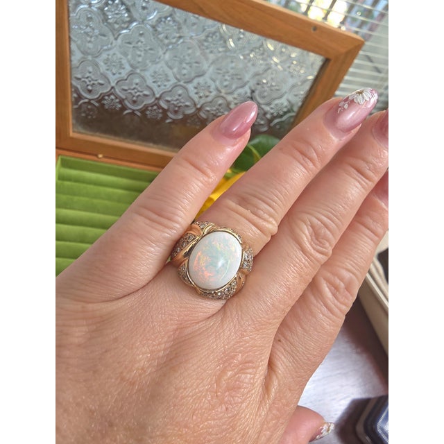 We offer free 2-day shipping! This is a vintage ring featuring a white Australian opal in a wide scallop ring with...
