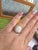 We offer free 2-day shipping! This is a vintage ring featuring a white Australian opal in a wide scallop ring with...